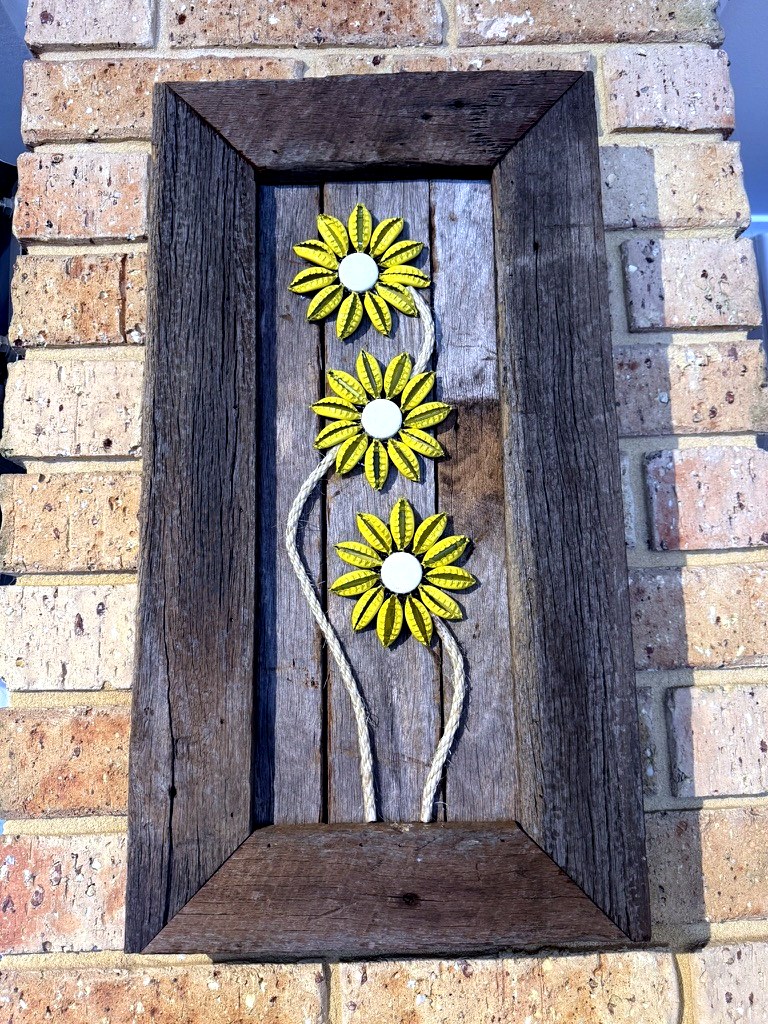 Recycled tin sunflower wall art in a timber frame