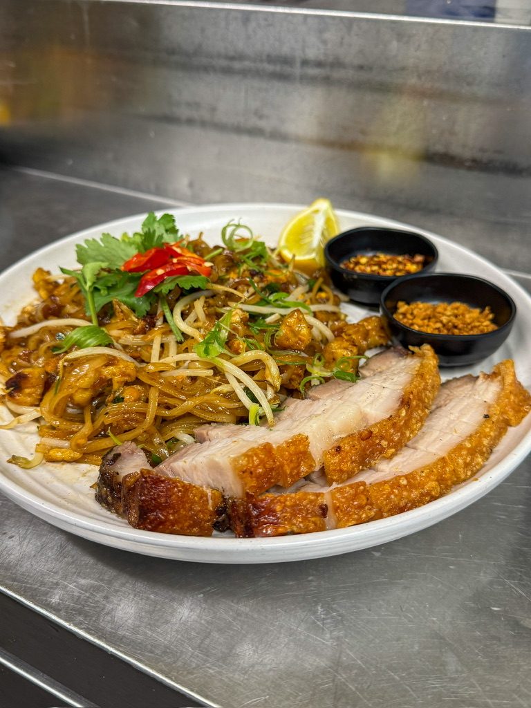 Pad Thai served with crispy roast pork
